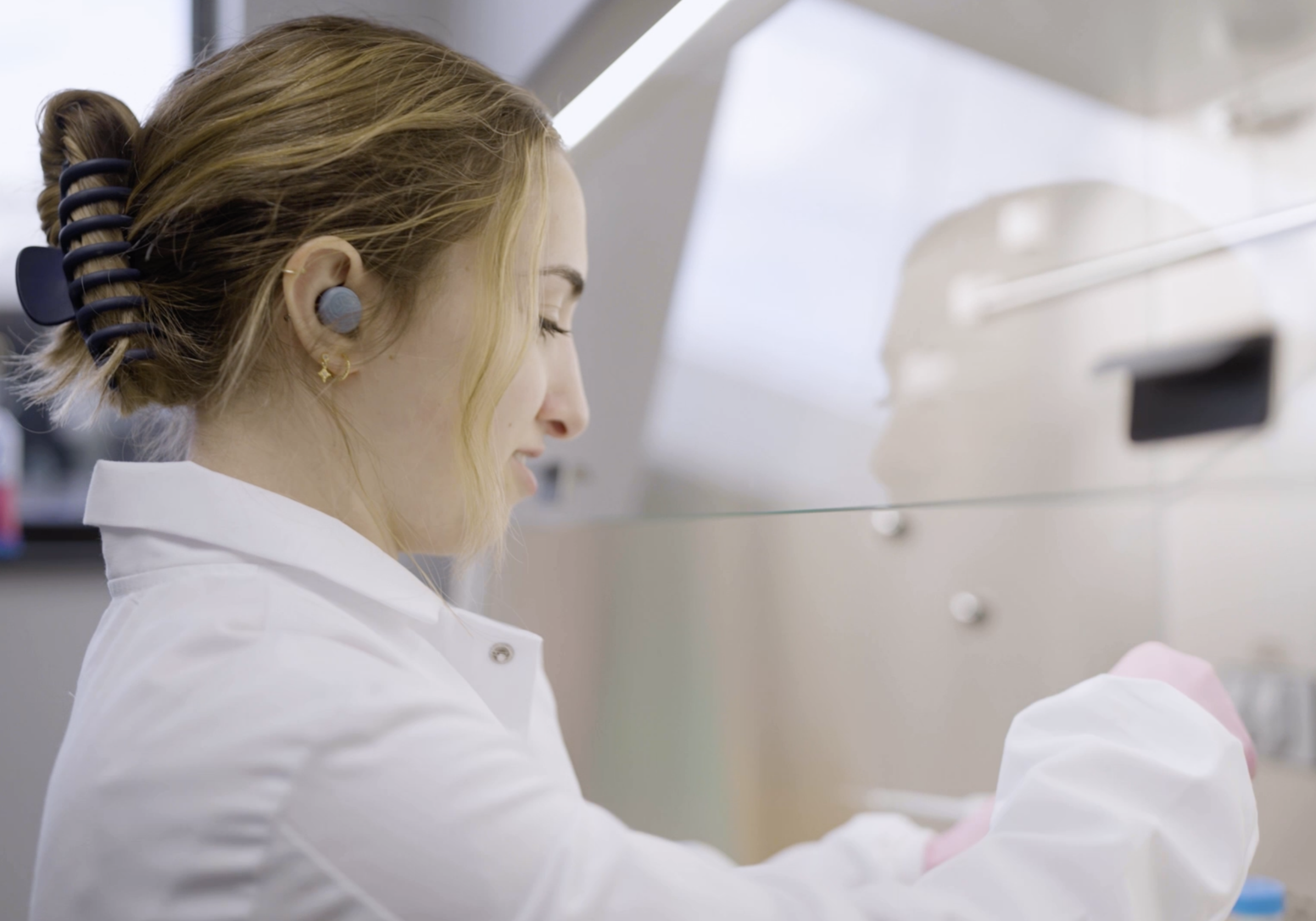 Woman working in a lab coat.